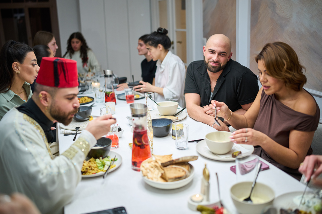 Gay Muslim influencer Ali Darwich, second right, hosts an inclusive Iftar, the Ramadan fast-breaking meal, with friends who are Muslim, Christian, queer and straight, in Berlin, Germany, Wednesday, March 11, 2026. (AP Photo/Ebrahim Noroozi)