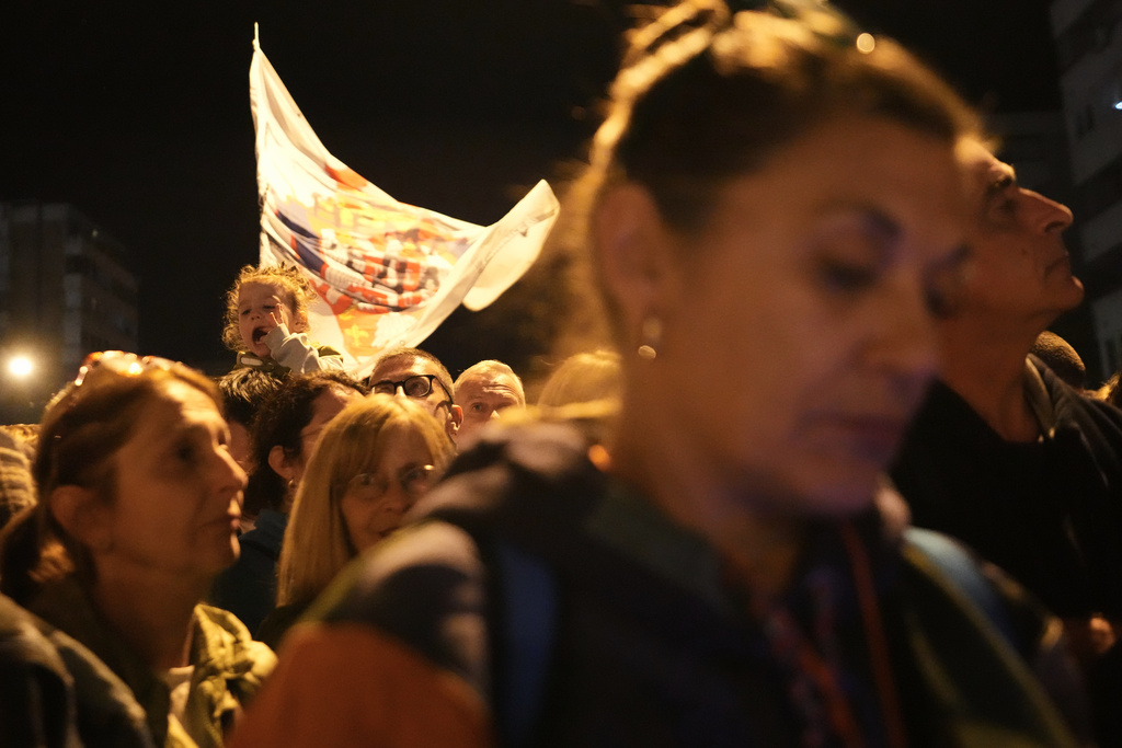 People welcome a group of students from southwestern town of Novi Pazar after marching to join a major rally marking the anniversary of a deadly train station disaster, in Novi Sad, Serbia, Friday, Oct. 31, 2025. (AP Photo/Darko Vojinovic)
