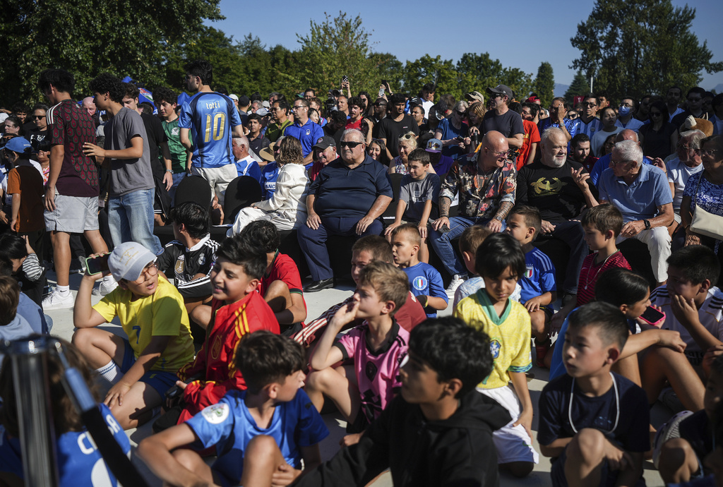 People wait to view the FIFA World Cup winner's trophy at the Italian Cultural Center in Vancouver, British Columbia, Tuesday, Aug. 26, 2025. (Darryl Dyck/The Canadian Press via AP)