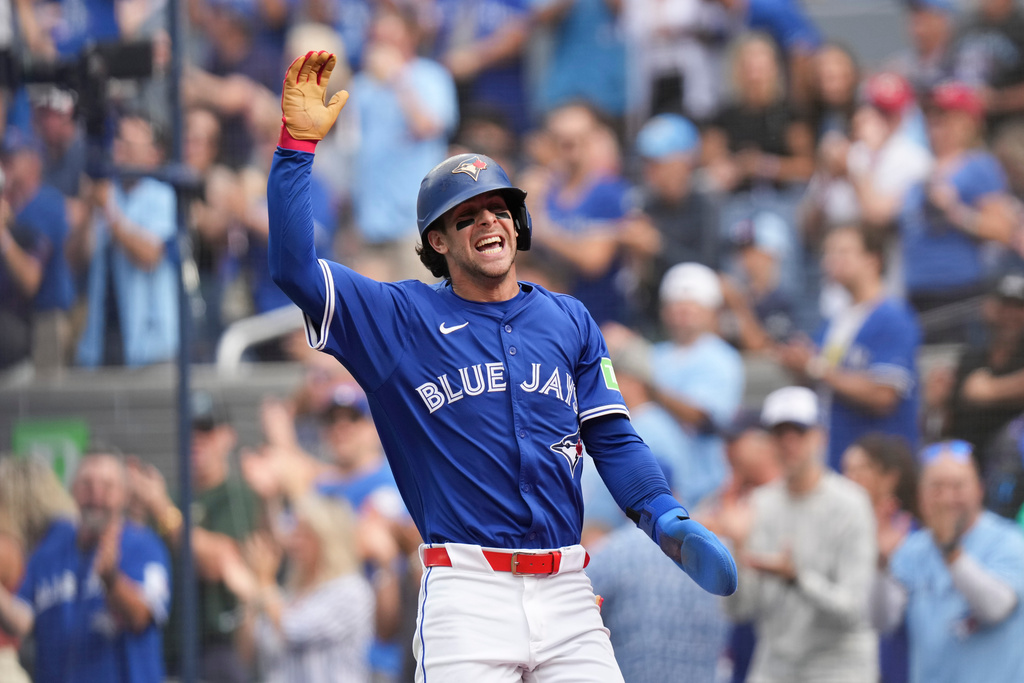 Toronto Blue Jays' Ernie Clement (22) celebrates scoring a run against the Tampa Bay Rays during second inning MLB baseball action in Toronto on Saturday, Sept. 27, 2025. (Chris Young/The Canadian Press via AP)