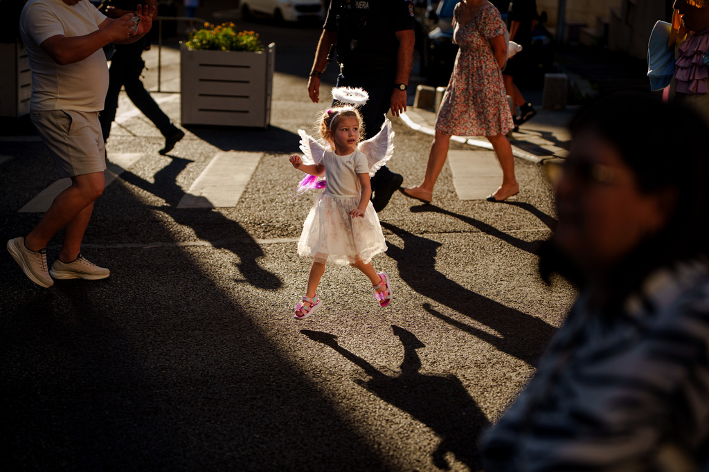 A child dressed as an angel runs during an event dubbed the Little Angels' Parade, a Christian-themed street performance featuring dozens of children wearing angel costumes, in Bucharest, Romania, Saturday, Sept. 5, 2026. (AP Photo/ Vadim Ghirda)
