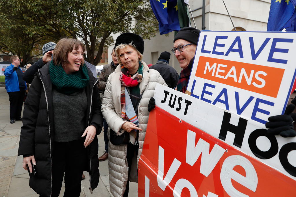 FILE - British conservative lawmaker Anna Soubry, centre, who campaigned to remain in the European Union during referendum debates, reacts with pro-Brexit protesters outside parliament in London, Thursday Jan. 10, 2019. (AP Photo/Alastair Grant, File)