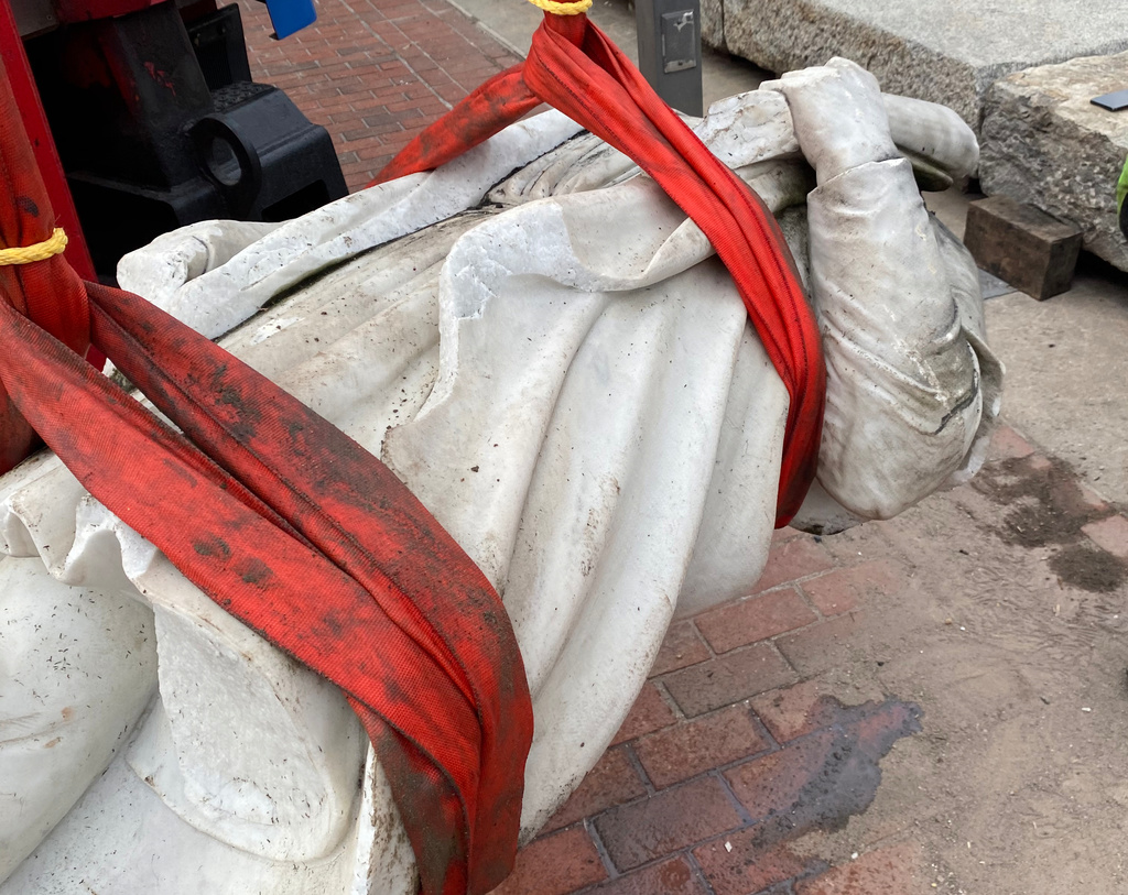 In this photo provided by Nino Mangione, a statue of Christopher Columbus is pulled out of the Inner Harbor in Baltimore, July 6, 2020, after protesters had thrown the statue into the harbor. (Nino Mangione via AP)
