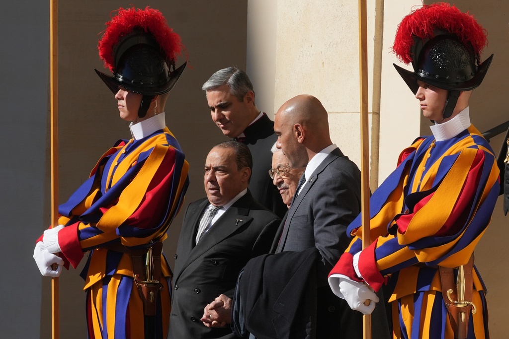 Palestinian President Mahmoud Abbas, also known as Abu Mazen, center, leaves the St. Damasus Courtyard at the Vatican after meeting with Pope Leo XIV, Thursday, Nov. 6, 2025. (AP Photo/Andrew Medichini)