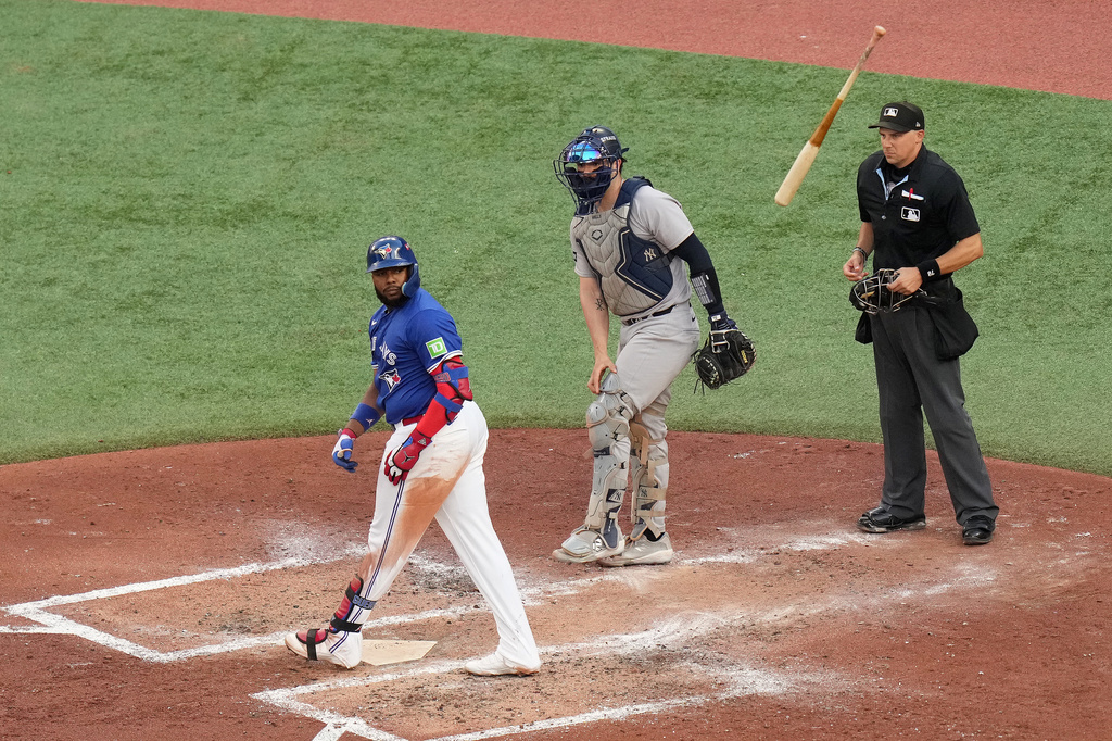 Toronto Blue Jays' Vladimir Guerrero Jr. reacts after hitting a grand slam off New York Yankees pitcher Will Warren (not shown) during the fourth inning of Game 2 of baseball's American League Division Series in Toronto, Sunday, Oct. 5, 2025. (Chris Young/The Canadian Press via AP)