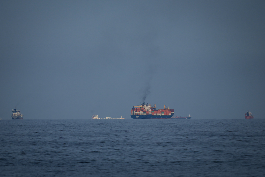 Oil tankers and cargo ships line up in the Strait of Hormuz as seen from Khor Fakkan, United Arab Emirates, Wednesday, March 11, 2026. (AP Photo/Altaf Qadri)