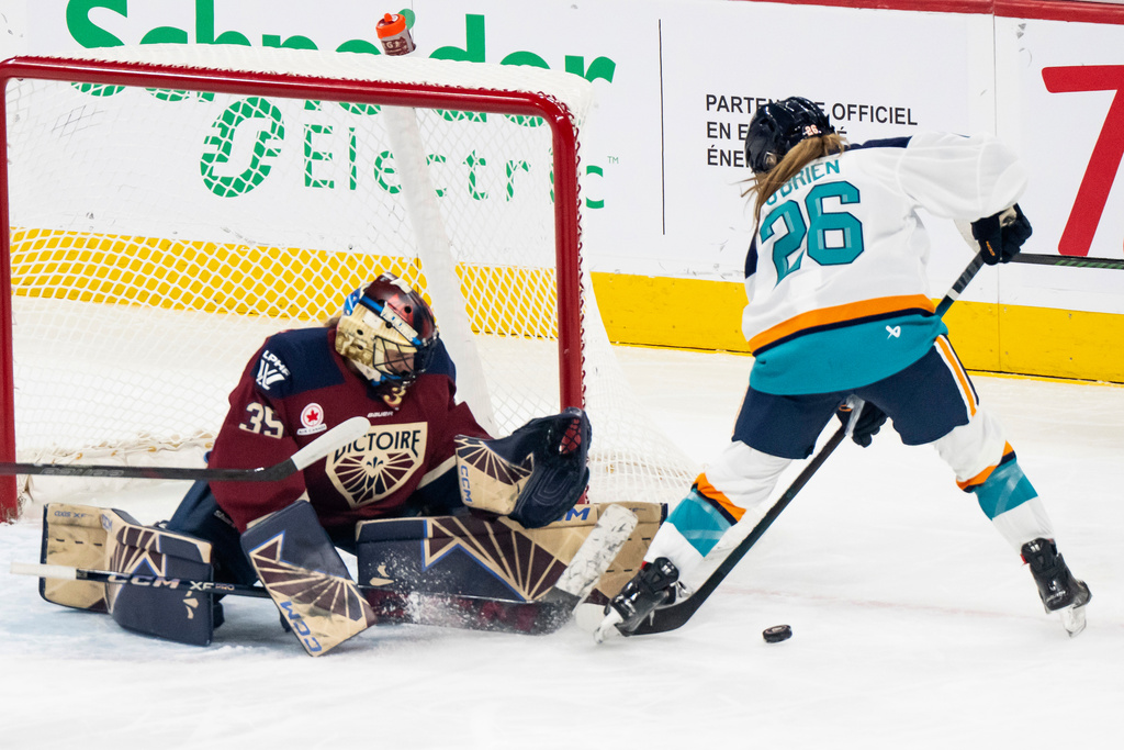 Montréal Victoire goaltender Ann-Renée Desbiens (35) makes a save on New York Sirens' Casey O'Brien (26) during first period PWHL hockey action in Tuesday, Nov. 25, 2025. (Christopher Katsarov/The Canadian Press via AP)
