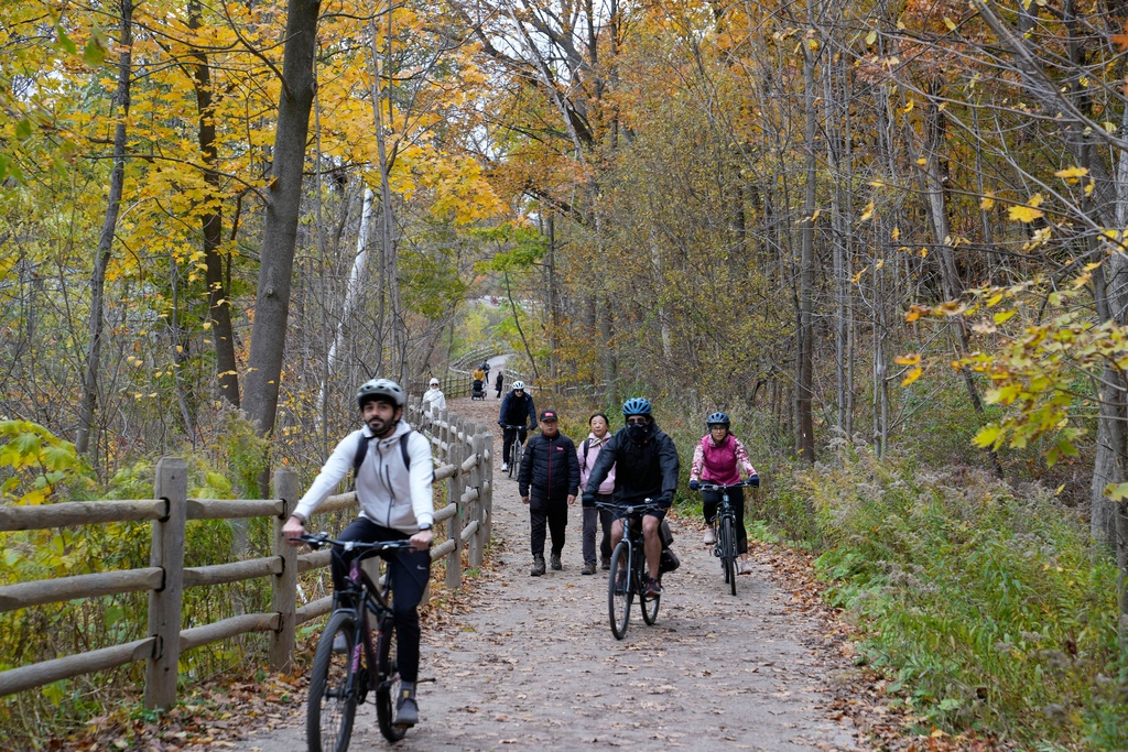 People ride their bikes at the Moore Park Ravine in Toronto, Sunday, Nov.2, 2025. (AP Photo/Kamran Jebreili)