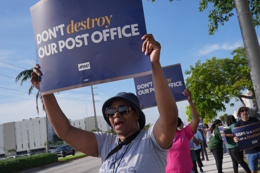 Yvonne Daniels demonstrates against proposed changes to the U. S. Postal Service and President Donald Trump's executive order regarding mail-in ballots Tuesday, July 28, 2026, in Miami Gardens, Fla. (AP Photo/Marta Lavandier)