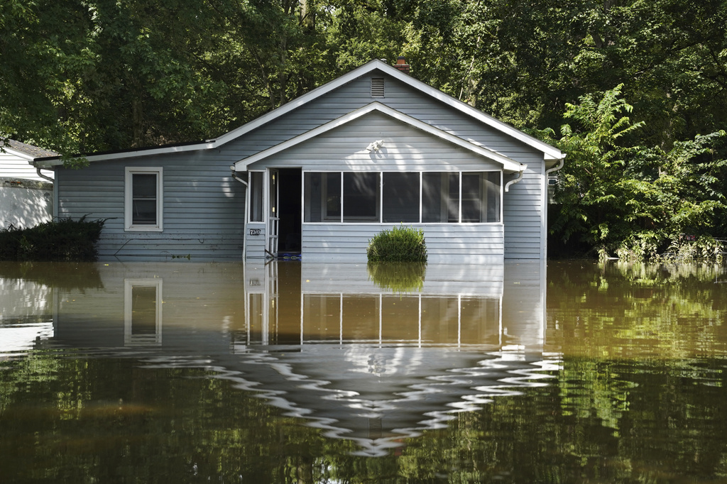 A flooded home is seen in Indianapolis, Sunday, Aug. 16, 2026. (AP Photo/Obed Lamy)
