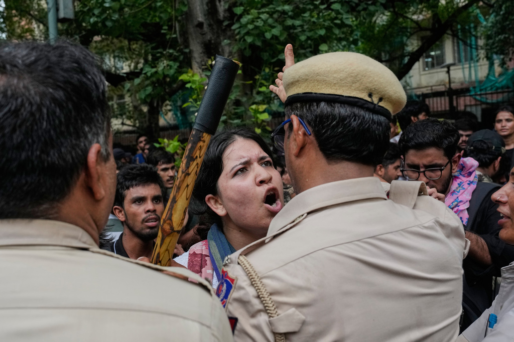 Supporters of the Cockroach Janta Party confront police as they attempt to march toward India's Parliament, demanding the resignation of the education minister, in New Delhi, India, Monday, July 20, 2026. (AP Photo/Manish Swarup)