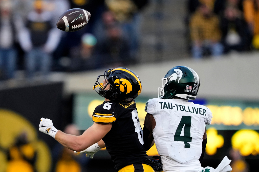 Iowa defensive back Zach Lutmer (6) intercepts a pass intended for Michigan State running back Elijah Tau-Tolliver (4) during the first half of an NCAA college football game, Saturday, Nov. 22, 2025, in Iowa City, Iowa. (AP Photo/Charlie Neibergall)