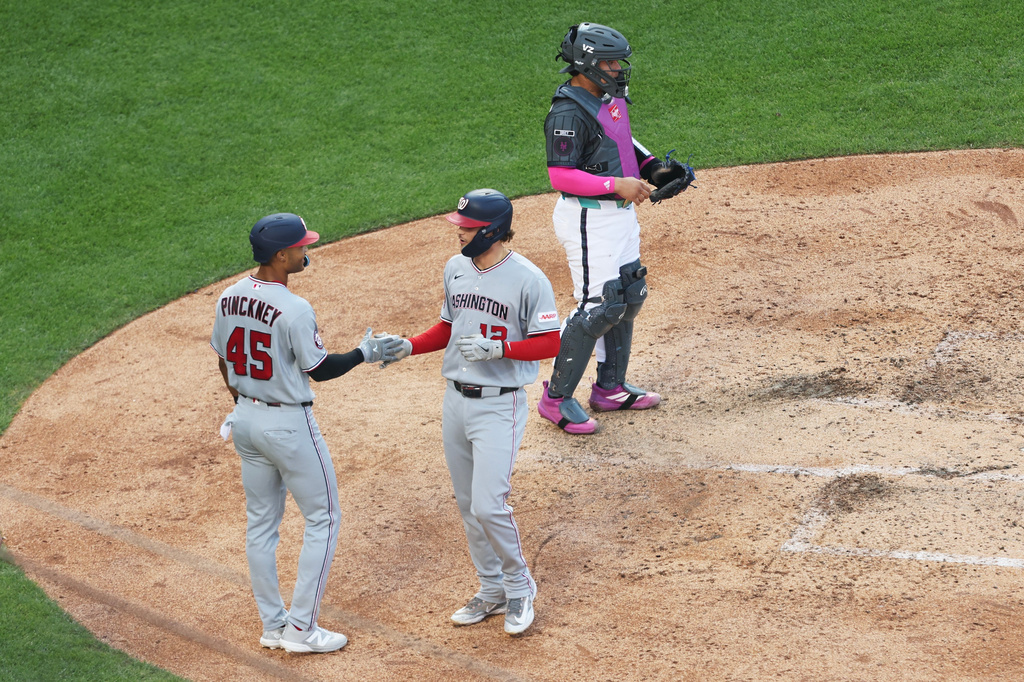 Washington Nationals' Brady House, right, high-fives Andrew Pinckney (45) after his home run during the sixth inning of a baseball game against the New York Mets, Saturday, Aug. 15, 2026, in New York. (AP Photo/Heather Khalifa)