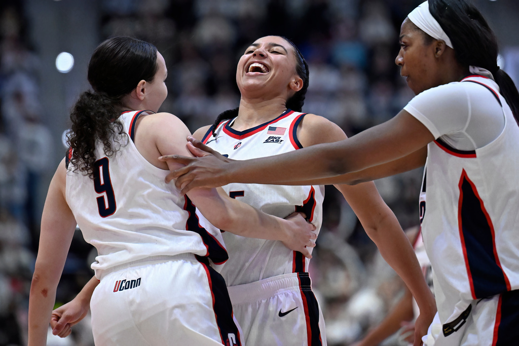 UConn guard Azzi Fudd, center, and UConn forward Serah Williams, right, celebrate after a basket by UConn guard Kayleigh Heckel, left, in the second half of an NCAA college basketball game against Tennessee, Sunday, Feb. 1, 2026, in Hartford, Conn. (AP Photo/Jessica Hill)