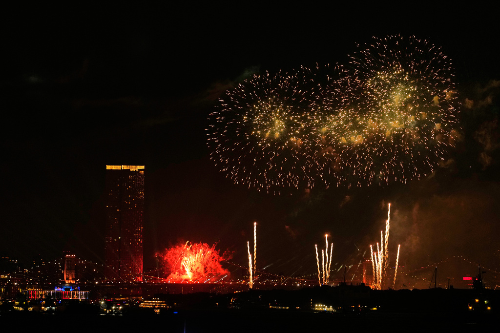 Fireworks explode over the Brooklyn Bridge during the New York City fireworks show, as seen from Bayonne, N.J., Saturday, July 4, 2026. (AP Photo/Seth Wenig)
