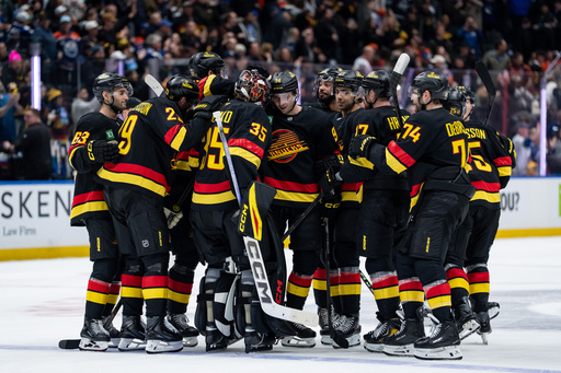 Vancouver Canucks teammates celebrate after defeating the Edmonton Oilers during overtime NHL hockey action in Vancouver, British Columbia, Sunday, Oct. 26, 2025. (Ethan Cairns/The Canadian Press via AP) Vancouver Canucks teammates celebrate after defeating the Edmonton Oilers during overtime NHL hockey action in Vancouver, British Columbia, Sunday, Oct. 26, 2025. (Ethan Cairns/The Canadian Press via AP)