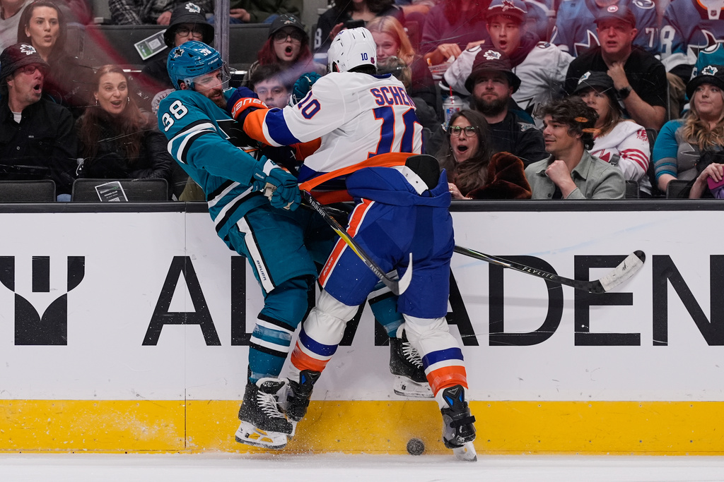 New York Islanders center Brayden Schenn (10) collides with San Jose Sharks defenseman Mario Ferraro (38) during the first period of an NHL hockey game, Saturday, March 7, 2026, in San Jose, Calif. (AP Photo/Godofredo A. Vásquez)