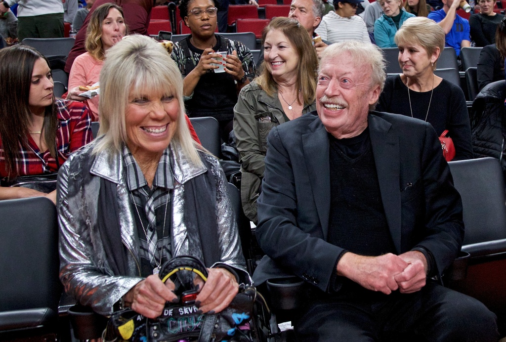FILE - Phil Knight, right, and Penny Knight, watch the first half of an NCAA college basketball game in the Phil Knight Invitational tournament in Portland, Ore., Nov. 26, 2017. (AP Photo/Craig Mitchelldyer, File)