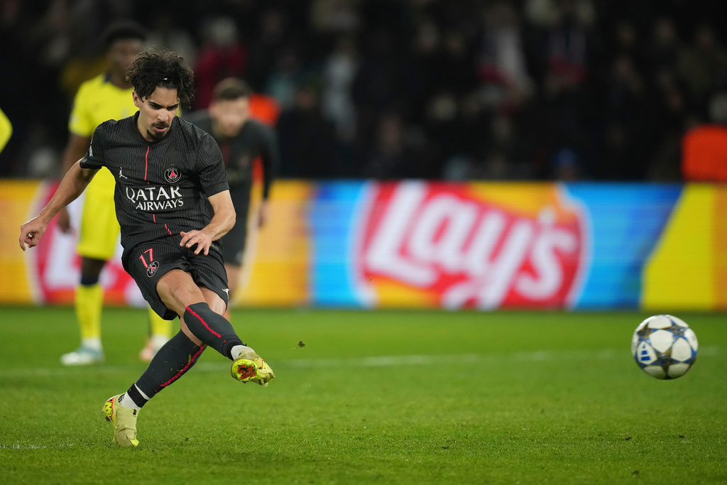 PSG's Vitinha scores on a penalty his side's fifth goal during a Champions League opening phase soccer match between Paris Saint Germain and Tottenham, in Paris, Wednesday, Nov.26, 2025. (AP Photo/Christophe Ena)