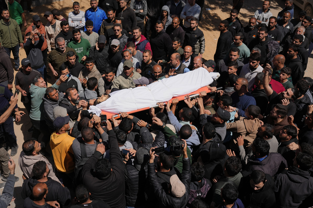 Mourners carry the body of Azzam al-Hayya, son of Hamas leader Khalil al-Hayya, mourn over his body after he was killed in an Israeli airstrike, at Shifa Hospital in Gaza City Thursday, May 7, 2026. (AP Photo/Jehad Alshrafi)