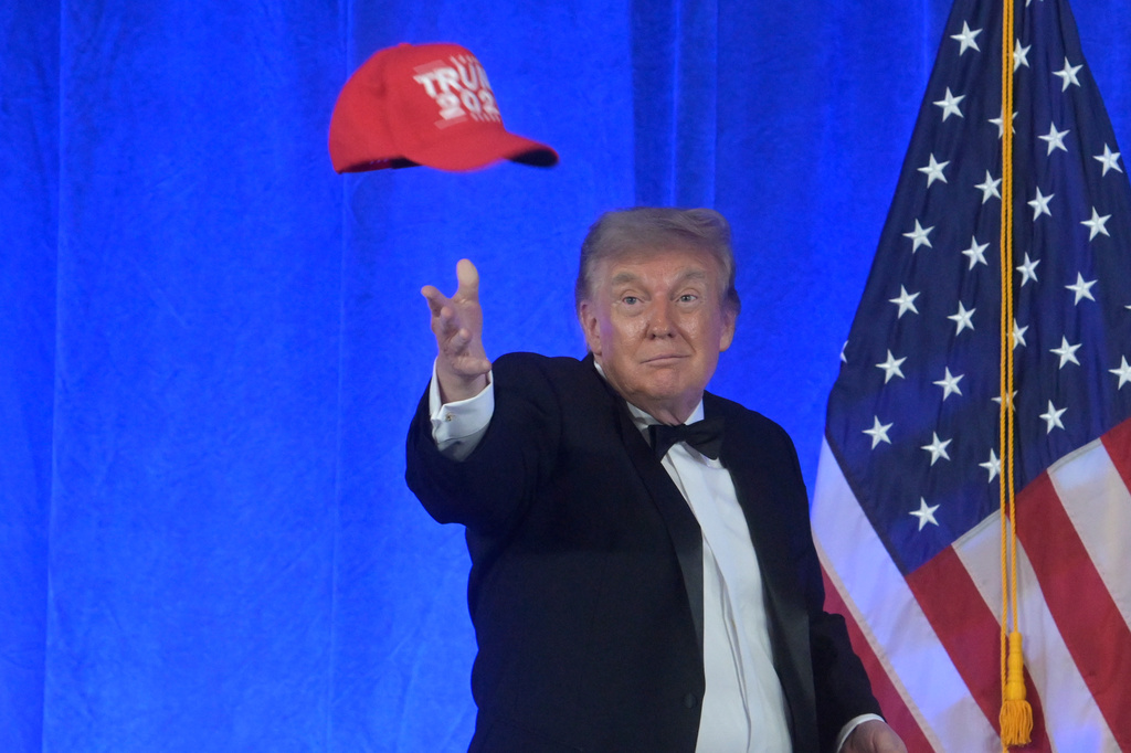 President Donald Trump tosses a "Trump 2028" hat at the White House Correspondents' Association dinner at the Waldorf Astoria Washington DC, Friday, July 24, 2026, in Washington. (AP Photo/Rod Lamkey, Jr.)