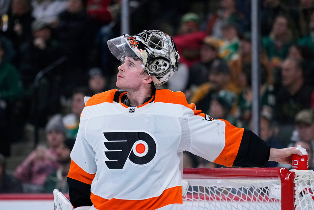FILE - Philadelphia Flyers goaltender Carter Hart waits for play to resume during the third period of an NHL hockey game against the Minnesota Wild, Thursday, Jan. 26, 2023, in St. Paul, Minn. (AP Photo/Abbie Parr, File)