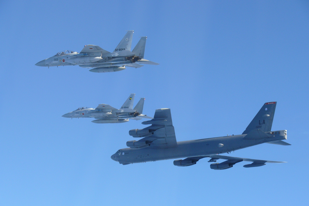 This photo provided by Japan's Ministry of Defense shows the Japan Air Self-Defense Force's F-15 fighters holding a joint military drill with the U.S. B-52 bomber in the vicinity of Japanese airspace on Wednesday Dec. 10, 2025. (Japan's Ministry of Defense via AP)