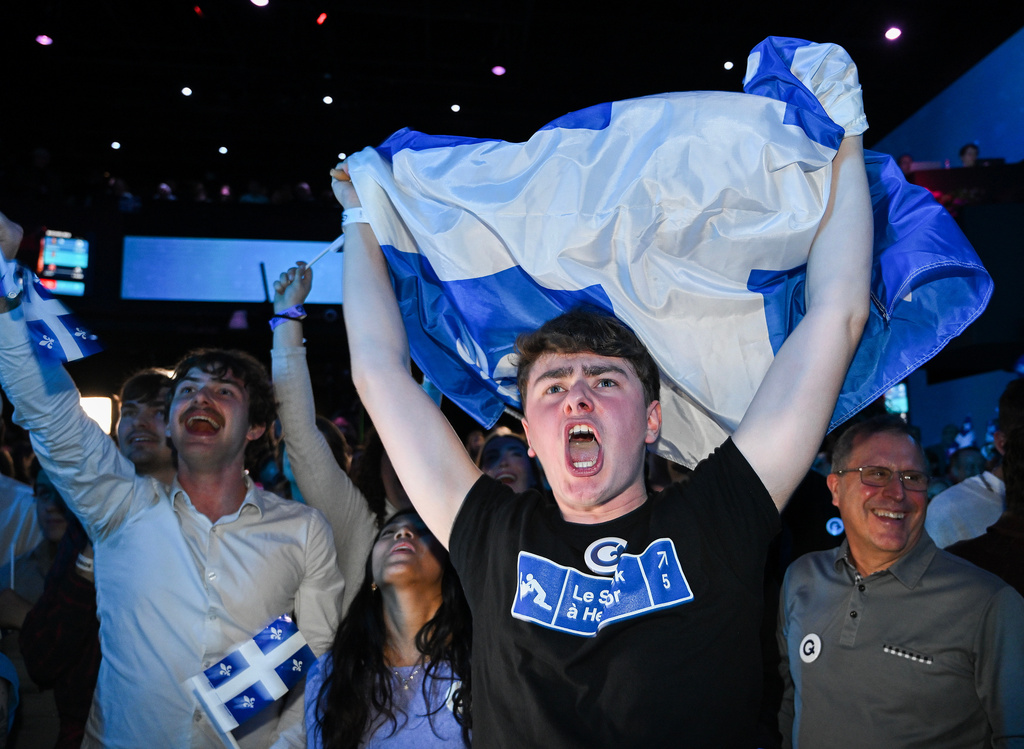 Parti Quebecois supporters cheer as results come in at PQ headquarters on election night in Montreal, Quebec on Monday, Oct. 5, 2026. (Graham Hughes/The Canadian Press via AP)