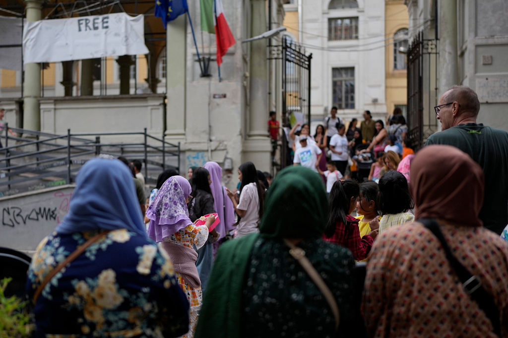 Parents and relatives wait for their children exit a school in downtown Rome, Thursday, Sept. 24, 2026. (AP Photo/Alessandra Tarantino)