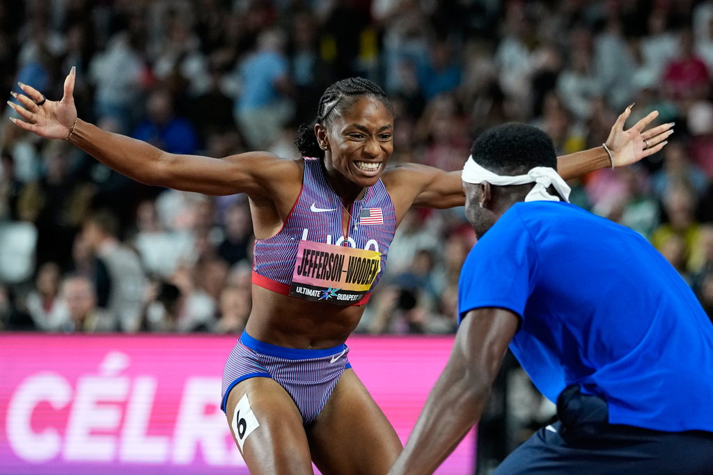 Melissa Jefferson-Wooden, of the United States, celebrates with sprinter Kenneth Bednarek, also of the United States, after winning the women's 200 meters final at the World Athletics Ultimate Championship in Budapest, Hungary, Sunday, Sept. 13, 2026. (AP Photo/Matthias Schrader)