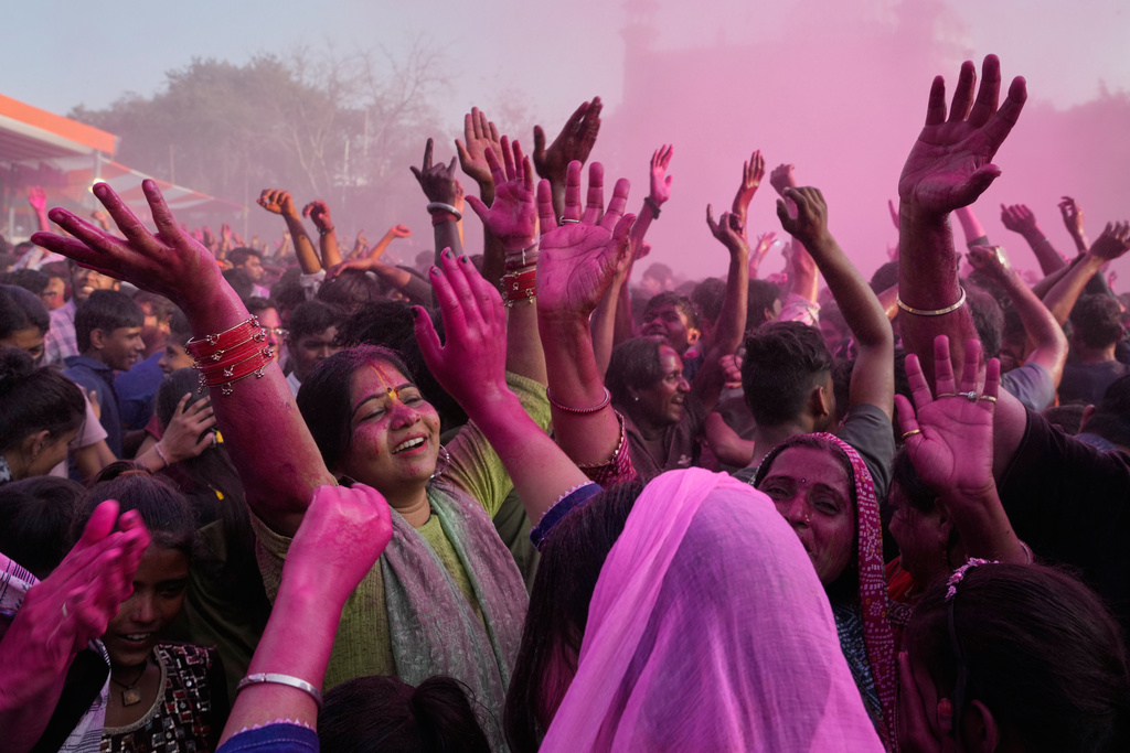 Devotees dance and sing during Holi festival celebrations as colored water is sprayed from above at the Shri Krishna Janmabhoomi Temple complex in Mathura, India, on Feb. 27, 2026. (AP Photo/Manish Swarup)