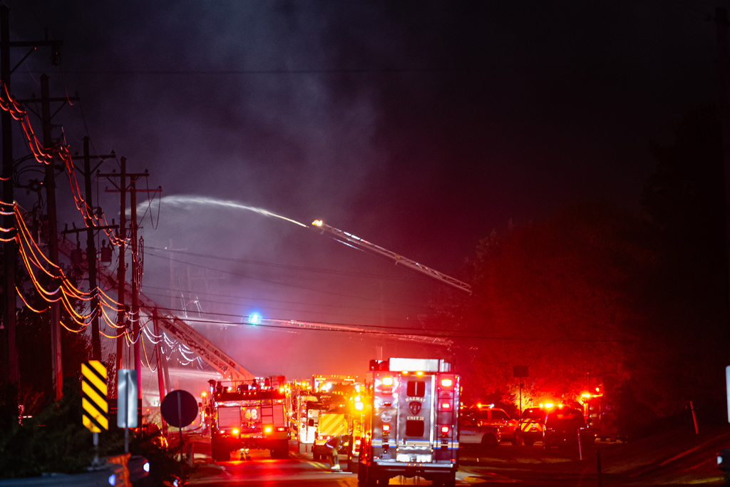 Plumes of smoke rise from the area of a plane crash at Louisville Muhammad Ali International Airport on Tuesday, Nov. 4, 2025, in Louisville, Ky. (AP Photo/Jon Cherry)