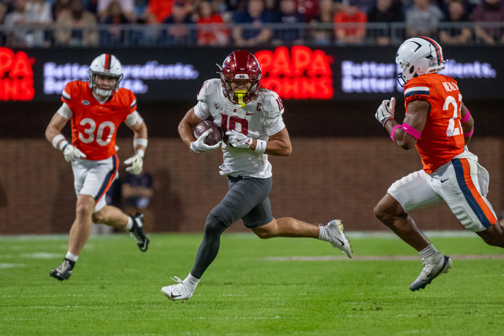 Washington State wide receiver Joshua Meredith (18) runs the ball downfield after catch against Virginia during the first half of an NCAA college football game, Saturday, Oct. 18 2025, in Charlottesville, Va. (AP Photo/Robert Simmons)