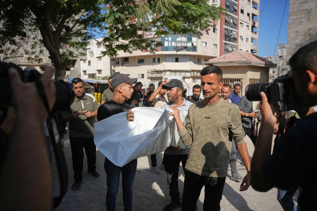 Mourners carry the bodies of two Palestinian girls Zeina Safadi, and her sister Lana, who were killed during an overnight Israeli airstrike that damaged their home, during their funeral in Gaza city, Saturday, June 20, 2026. (AP Photo/Abdel Kareem Hana)