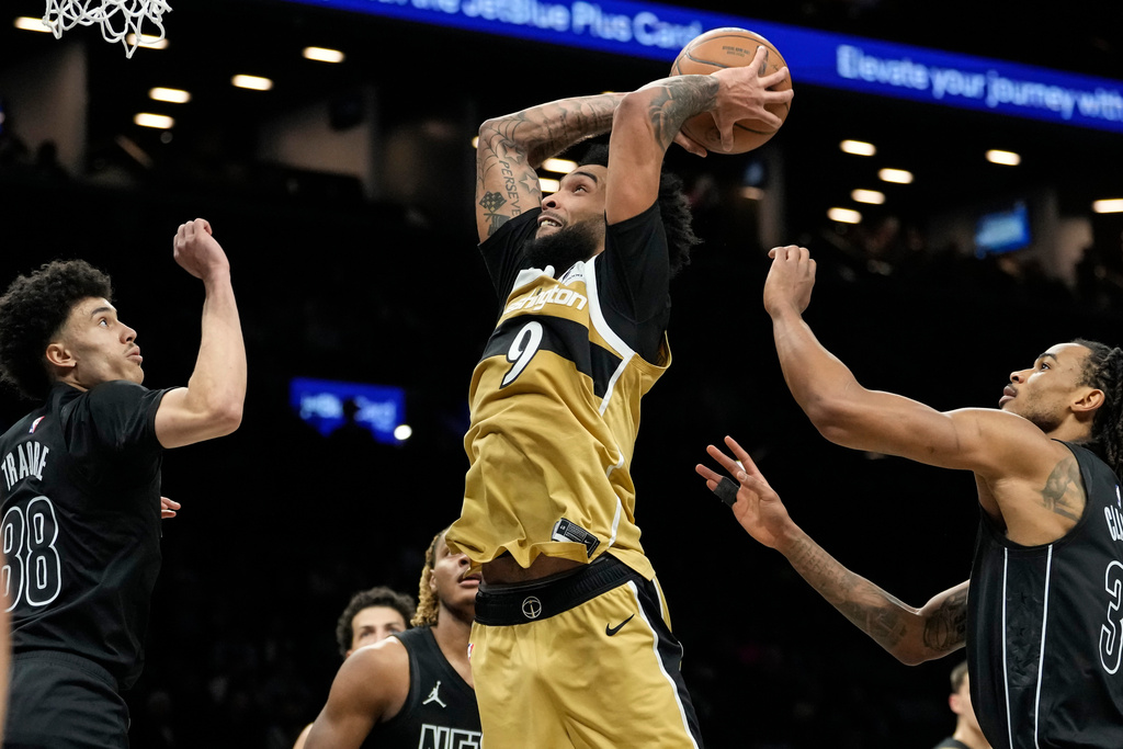 Washington Wizards forward Justin Champagnie (9) dunks during the second half of an NBA basketball game against the Brooklyn Nets, Saturday, Feb. 7, 2026, in New York. (AP Photo/Yuki Iwamura)