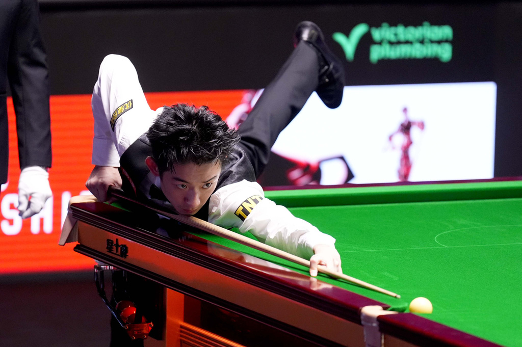 China's Wu Yize during his match against England's Shaun Murphy on day sixteen of the World Snooker Championship 2026 in Sheffield, England, Sunday, May 3, 2026. (Mike Egerton/PA via AP)