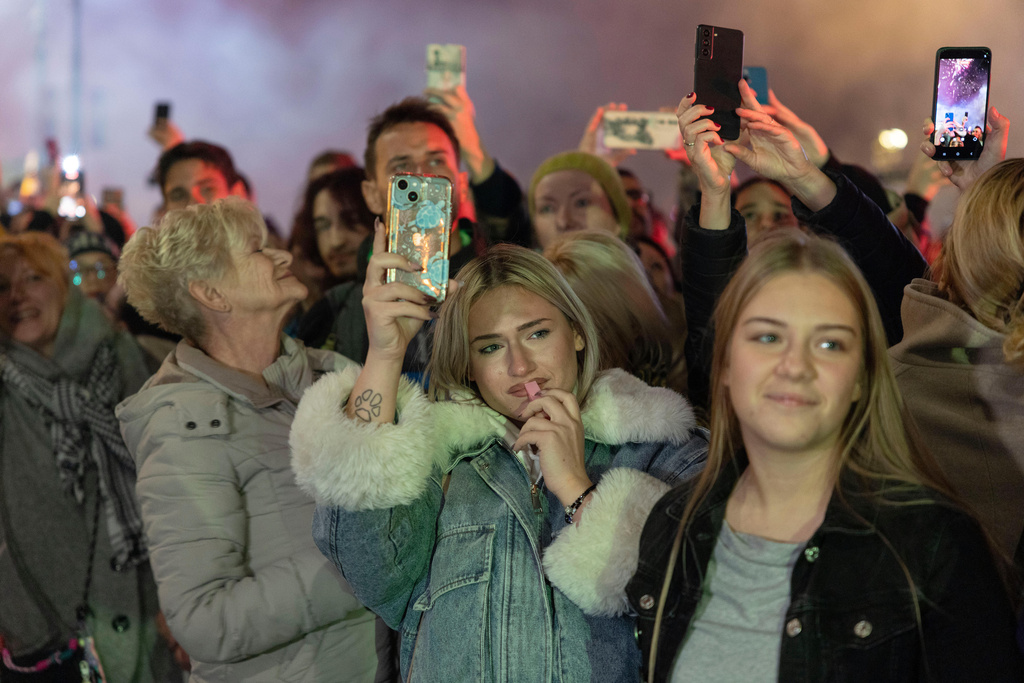 People crowd a street as they welcome a group of students from the southwestern town of Novi Pazar as they march towards the northern city of Novi Sad, for a rally on Nov. 1 marking the first anniversary of a train station disaster that killed 16 people, in Belgrade, Serbia, Tuesday, Oct. 28, 2025. (AP Photo/Marko Drobnjakovic)