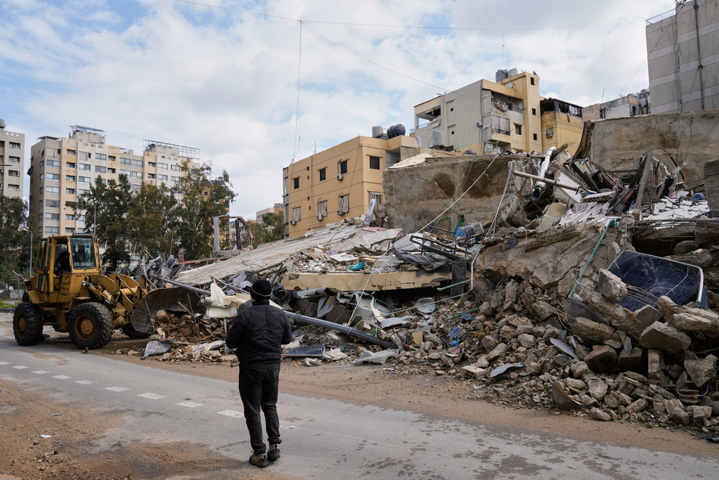 A bulldozer clears debris from the rubble of buildings destroyed in an Israeli airstrike, in Dahiyeh, Beirut's southern suburbs,, Lebanon, Monday, March 16, 2026. (AP Photo/Bilal Hussein)