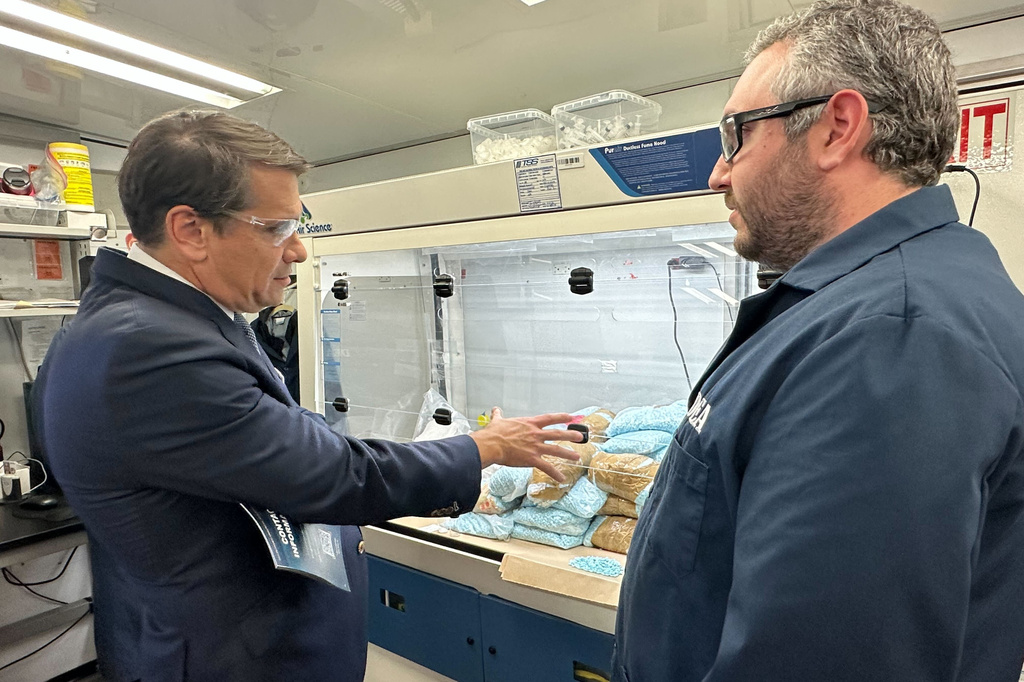 Acting Attorney General Todd Blanche talks to a technician in a Drug Enforcement Administration (DEA) mobile lab who is running tests on seized drugs in Phoenix, Wednesday, May 6, 2026. (AP Photo/Rebecca Santana)