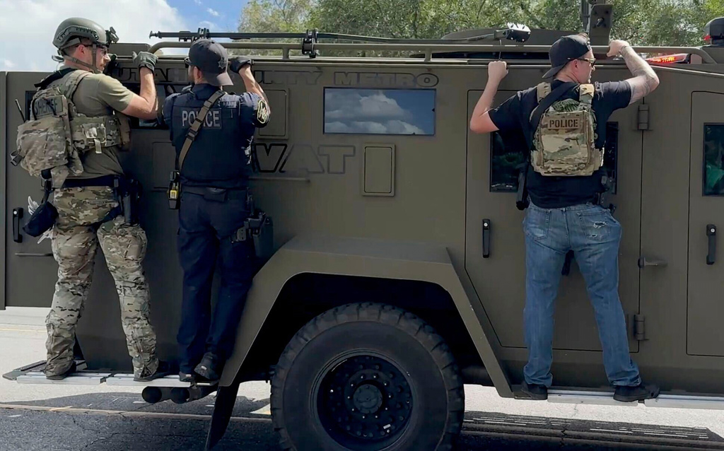 In this image taken from video, SWAT heads into campus after Charlie Kirk was shot during Turning Point's visit to Utah Valley University in Orem, Utah, Wednesday, Sept. 10, 2025. (AP Photo/Hannah Schoenbaum)