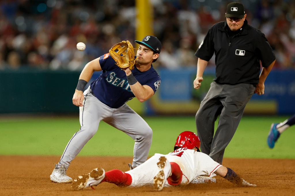 Seattle Mariners second baseman Cole Young (2) readies to catch the ball as Los Angeles Angels' Zach Neto (9) slides into second base during the fourth inning of a baseball game Wednesday, Sept. 16, 2026, in Anaheim, Calif. (AP Photo/Caroline Brehman)