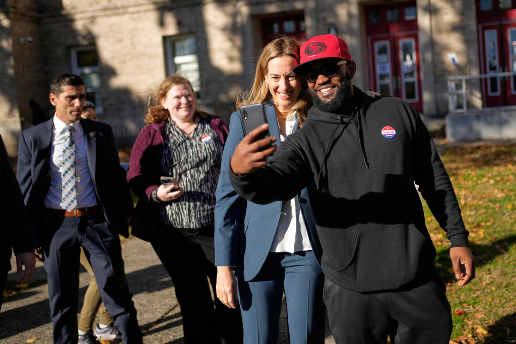New Jersey gubernatorial candidate Mikie Sherrill, second from right, takes a picture with Frank Saint-Fort, right, after they both voted in Montclair, N.J., Tuesday, Nov. 4, 2025. (AP Photo/Seth Wenig)