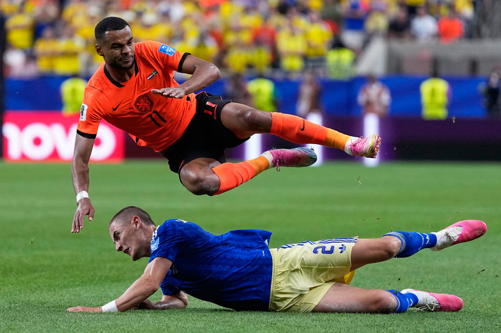Netherlands' Cody Gakpo falls over Sweden's Gustaf Lagerbielke during the World Cup Group F soccer match between the Netherlands and Sweden in Houston, Saturday, June 20, 2026. (AP Photo/Ashley Landis)