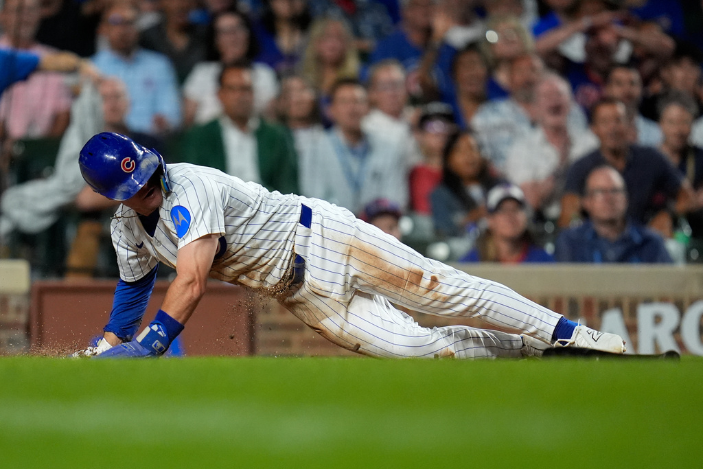 Chicago Cubs' Matt Shaw (6) scores on a single from Michael Busch (29) during the sixth inning of the second baseball game of a split doubleheader against the Milwaukee Brewers, Tuesday, Aug. 19, 2025, in Chicago. (AP Photo/Erin Hooley)