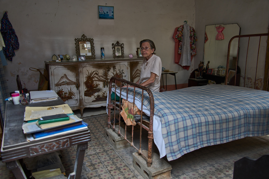 Carmen Casado, 84, sits on her bed in her home in Old Havana, Cuba, Tuesday, April 21, 2026. (AP Photo/Ramon Espinosa)