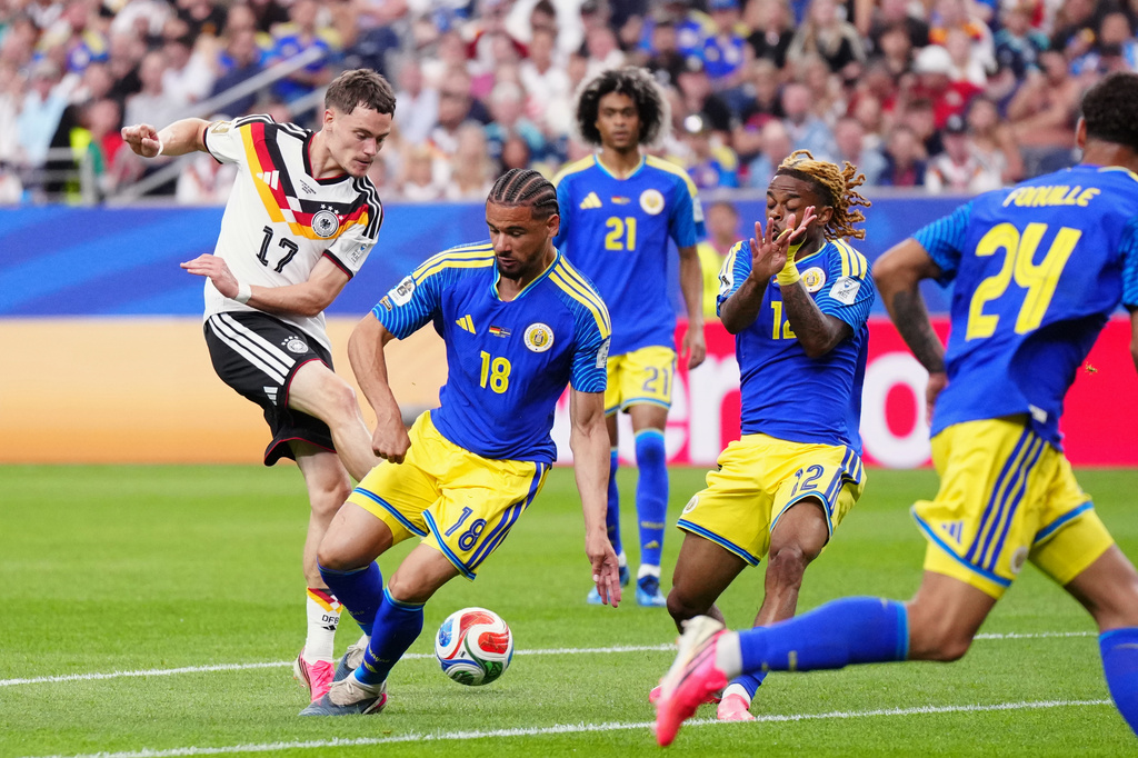 Germany's Florian Wirtz, left, attempts a shot at goal during the World Cup Group E soccer match between Germany and Curacao in Houston, Sunday, June 14, 2026. (AP Photo/Karen Warren)