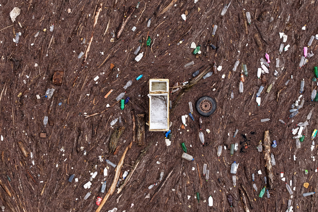 An aerial view shows a fridge and a car tire amongst other waste clogging the Drina river in Visegrad, Bosnia, Thursday, Feb. 5, 2026. (AP Photo/Armin Durgut)