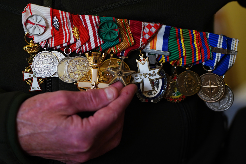 Former Colonel Soren Knudsen shows his United States Bronze Star Medal for a photo during an interview with The Associated Press at his home in Copenhagen, Denmark, Tuesday, Jan. 13, 2026. (AP Photo/Anders Garde Kongshaug)