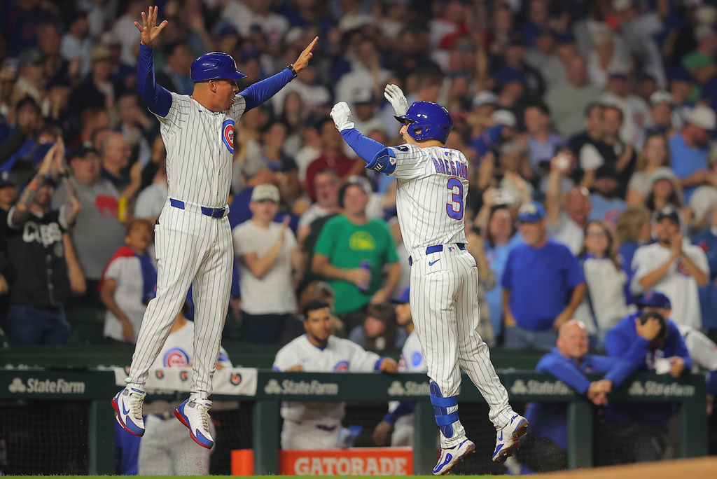 Chicago Cubs' Alex Bregman, right, celebrates his home run with third base coach Quintin Berry, left, during the fourth inning of a baseball game against the Atlanta Braves, Wednesday, Sept. 16, 2026, in Chicago. (AP Photo/Melissa Tamez)