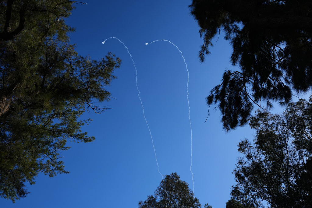 Israeli air defense systems fire to intercept projectiles launched from Lebanon over northern Israel, Tuesday, March 17, 2026. (AP Photo/Ariel Schalit)